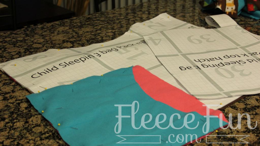 cutting the outside pocket. I love this sleeping bag pack that turns into a backpack! It's a free sewing pattern and there is a video to make it easy! This sleeping bag pack how to is a great DIY sewing project.