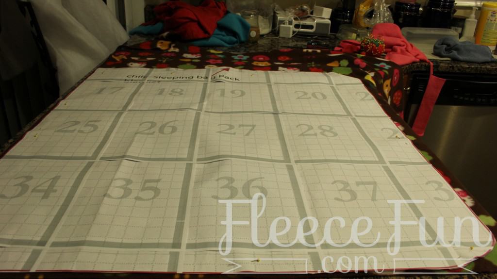cutting the back pack base. I love this sleeping bag pack that turns into a backpack! It's a free sewing pattern and there is a video to make it easy! This sleeping bag pack how to is a great DIY sewing project.