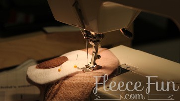 Adding eyes and mouth to fleece hat in step 2 of fleecefun free template tutorial
