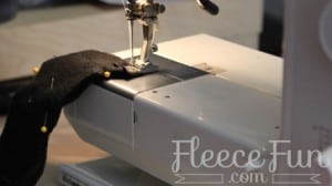 Sewing the antennae onto the fleece ladybug hat in the tutorial