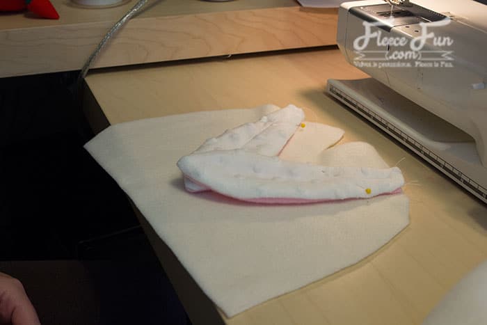 Attaching the bunny ears to the fleece hat and completing the construction