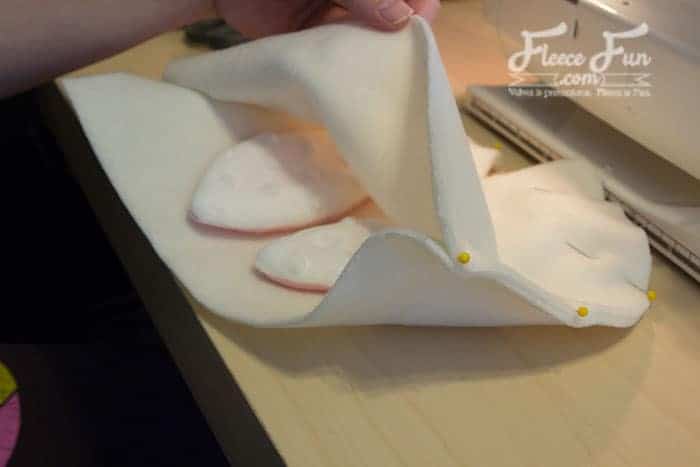 Sew one seam along the top of the hat closing the v on both sides.
