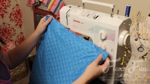 sewing the cape lining.I love this cute easy superhero cape DIY! It goes around the arms and not the neck for safe play - plus you can turn it around to be a blanket for baby! Easy sewing idea.
