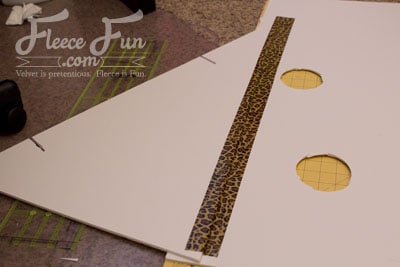 Taping down into place with the triangle pointing out.
