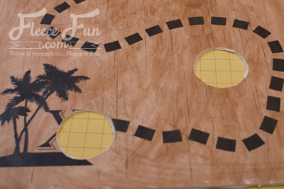 Cutting holes for the Captain Hooks. This Pirate Party DIY Captain Hook’s Ring Toss is the perfect game for your little pirates. With a free jumbo printable and step-by-step instructions, you’ll build a sturdy, sea-worn game board that’s fun for all ages. The rope rings are quick to make, and the whole project is designed to last for many swashbuckling parties ahead.