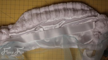 cutting the satin binding.  I love this cute Frozen inspired Elsa cape. tutorial it's a jacket and cape fit for a queen. The cold might not have bothered Elsa, but it might bother my little one while trick or treating and this is perfect. Love this sewing costume DIY with free pattern.