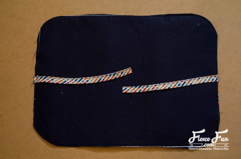 Adding the ties. This travel shaving kit is handmade, sleek, and super practical—with compartments that actually make sense. With our step-by-step tutorial, you can stitch one up and customize the fabric to fit his style. It’s the perfect blend of rugged and personal. He’ll use it more than once.