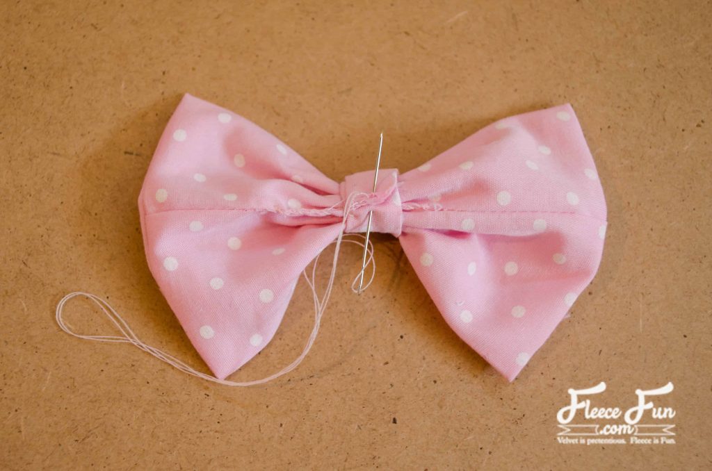 sewing the bow center. I love this fleecy sheep purse pattern and tutorial. Such a great handmade gift DIY idea and perfect sewing for a little girl.