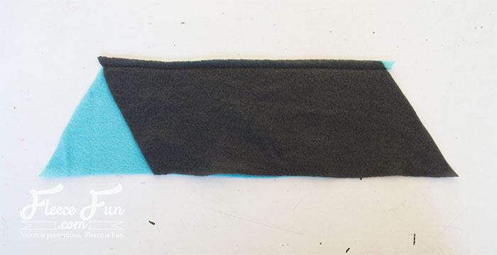 sewing the pieces together. This color-blocked cowl is giving cozy with a side of geometry. If scarves are your love language, this fleece accessory is about to be your new favorite. It's soft, stylish, and surprisingly simple to make. This free PDF pattern and step-by-step tutorial walks you through the color blocking and donut-style twist—no confusion, no regrets, just one perfect loop.

