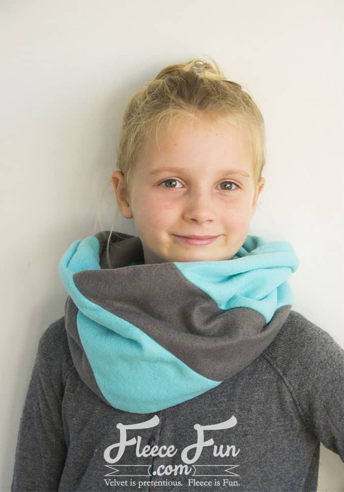 This color-blocked cowl is giving cozy with a side of geometry. If scarves are your love language, this fleece accessory is about to be your new favorite. It's soft, stylish, and surprisingly simple to make. This free PDF pattern and step-by-step tutorial walks you through the color blocking and donut-style twist—no confusion, no regrets, just one perfect loop.
