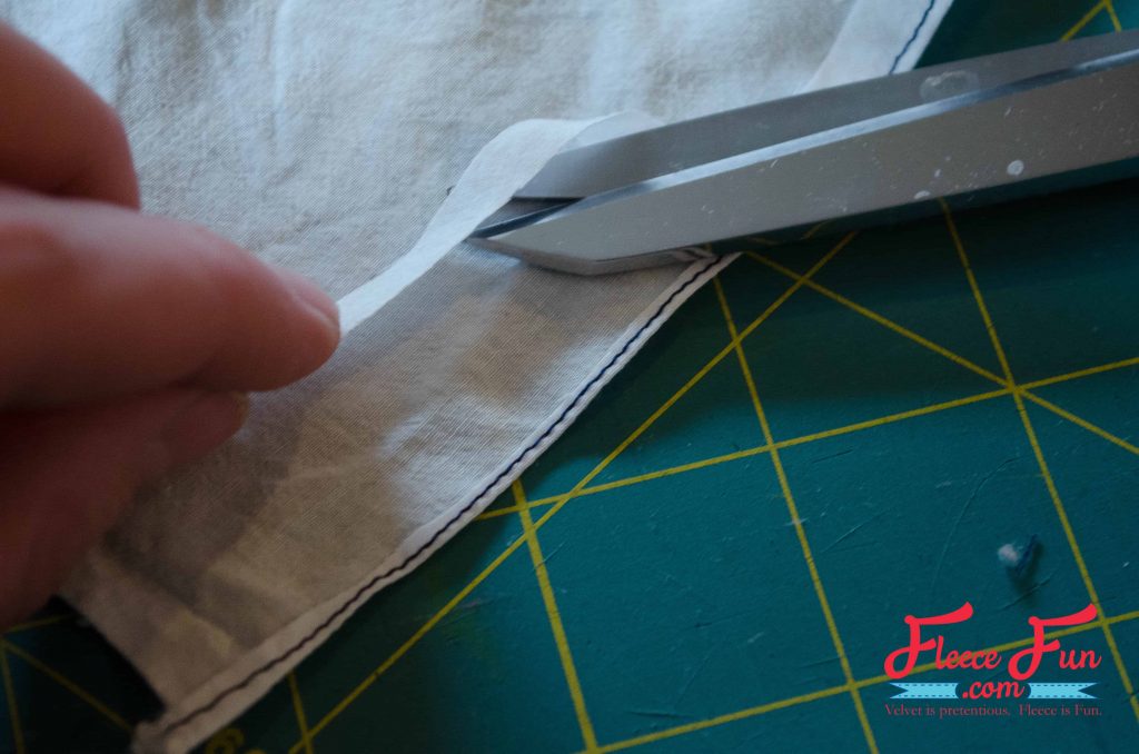 Trimming the fabric. This hand stamped scarf tutorial shows you how to turn a blank scarf into a statement piece—no fancy tools needed. With just a stamp, some paint, and a little time, you’ll end up with a one-of-a-kind accessory that’s uniquely you. It’s simple, fun, and makes the perfect handmade gift.