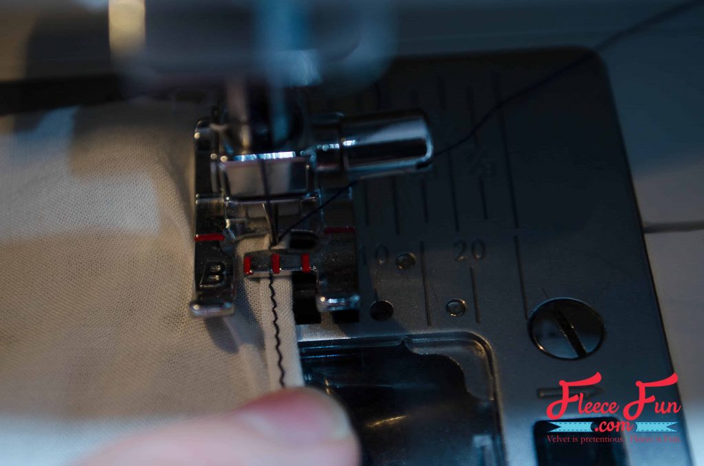 Folding the stitched line over to the wrong side.