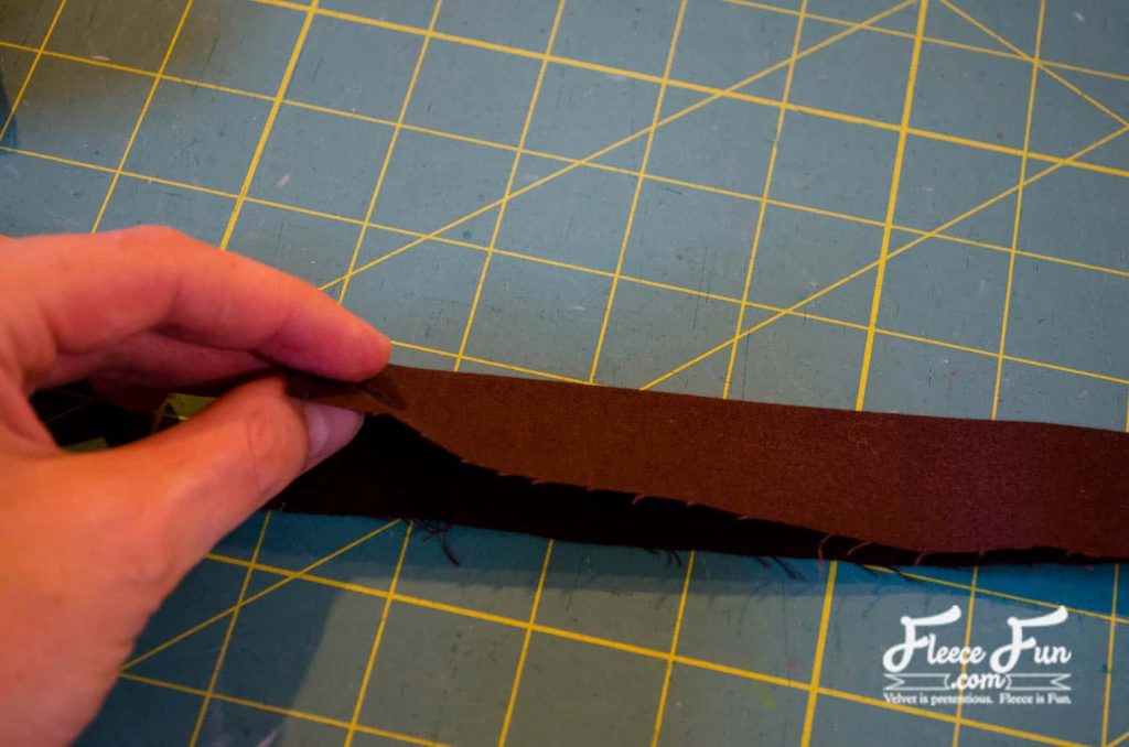 pressing the long strip in half