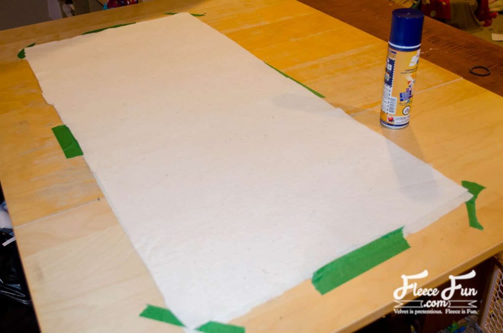 Quilted table runner assembly step showing how to add backing fabric using fleecefun sewing guide
