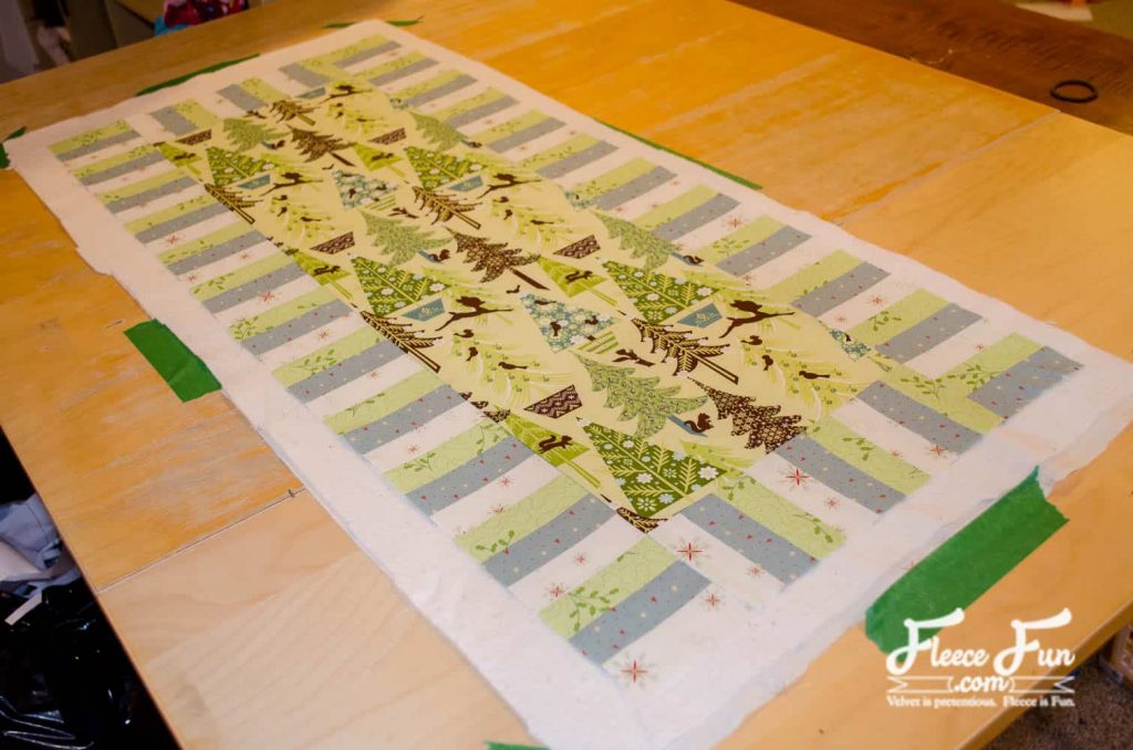Backing fabric carefully sewn to the Christmas quilted table runner with fleecefun free sewing tutorial