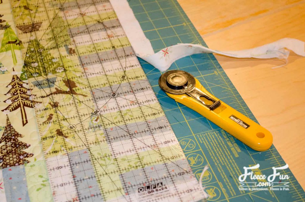 trimming the backing and batting for an even quilt top