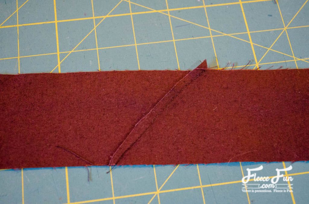 Adding binding to finish the quilted Christmas table runner using fleecefun free sewing tutorial