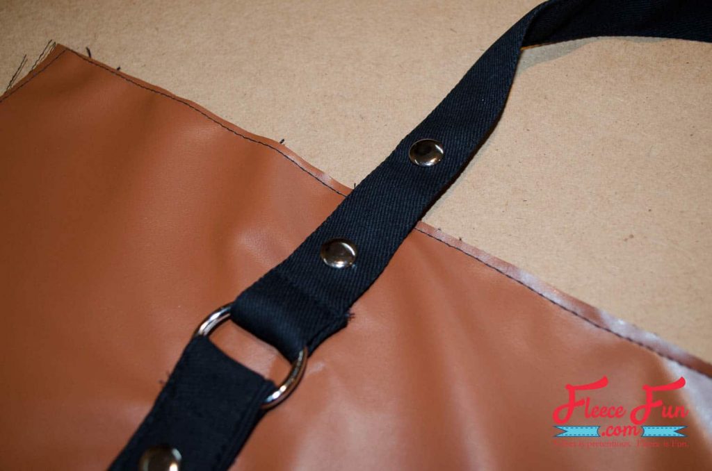 placing the straps on the bag. This tote is giving “I made this” energy. I wanted something sturdy enough for books, groceries, and weekend trips—but cute enough to gift. This leather-look tote checks all the boxes. It’s lined with a fun acorn print, stitched in faux leather, and honestly feels store-bought. Made with free step by step tutorial at FleeceFun.com