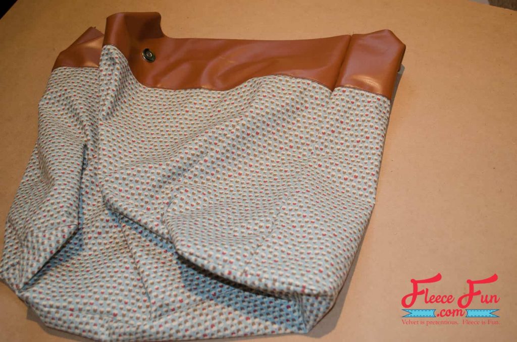 completed lining with base and sides.This Leather Tote Bag is giving “I made this” energy. I wanted something sturdy enough for books, groceries, and weekend trips—but cute enough to gift. This leather-look tote checks all the boxes. It’s lined with a fun acorn print, stitched in faux leather, and honestly feels store-bought. Made with free step by step tutorial at FleeceFun.com