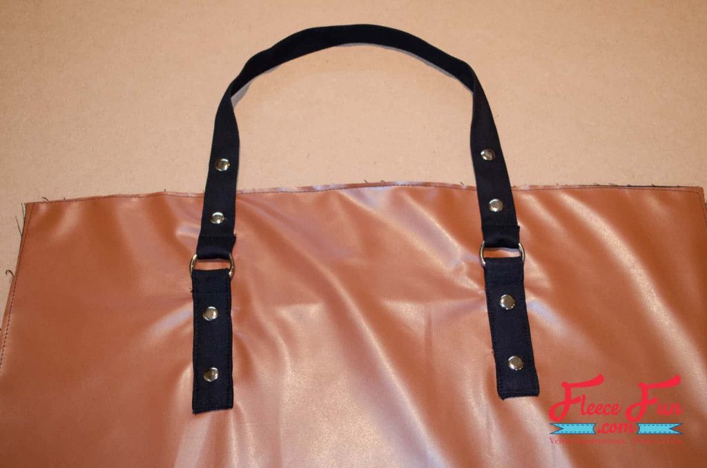 sewing the straps on to the bag. This Leather Tote Bag is giving “I made this” energy. I wanted something sturdy enough for books, groceries, and weekend trips—but cute enough to gift. This leather-look tote checks all the boxes. It’s lined with a fun acorn print, stitched in faux leather, and honestly feels store-bought. Made with free step by step tutorial at FleeceFun.com