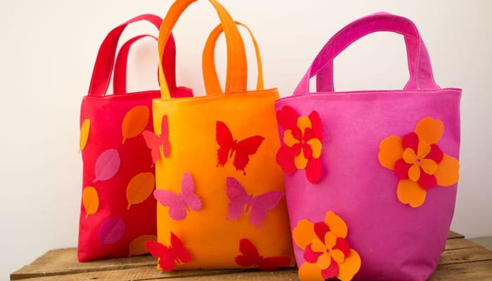Learn how to make a book tote bag with these simple and clear step by step instructions. This easy sewing DIY is a great craft for kids to decorate. It's also a beginner friendly pattern.