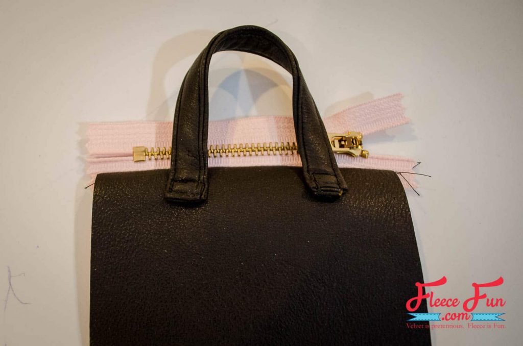 Sewing the zipper onto the DIY purse using fleecefun’s free pattern and tutorial