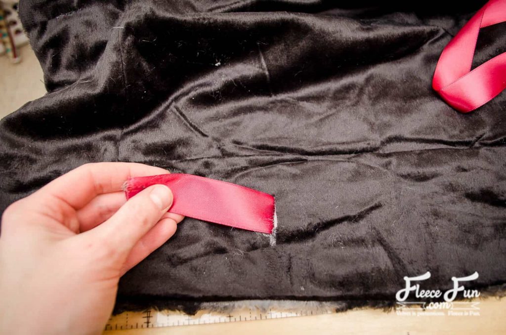 Final step: Thread the ribbon and complete your fleece throw with this fleecefun tutorial