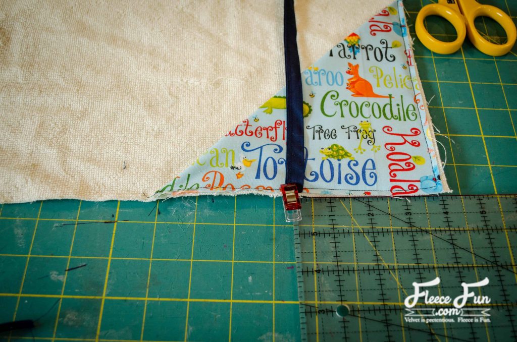 pinning the ties on the corner. I love this sewing project for babies. This diaper changing mat is simple to make and the perfect addition to any diaper bag or purse! fleece fun waterproof change mat tutorial