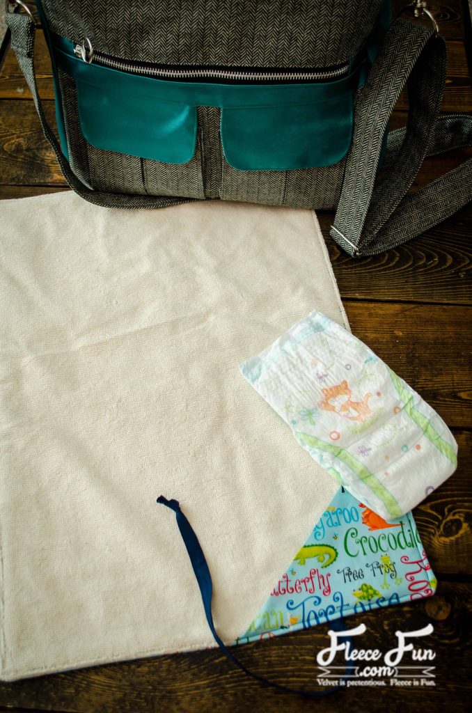 finished changing mat. I love this sewing project for babies. This diaper changing mat is simple to make and the perfect addition to any diaper bag or purse! fleece fun waterproof change mat tutorial