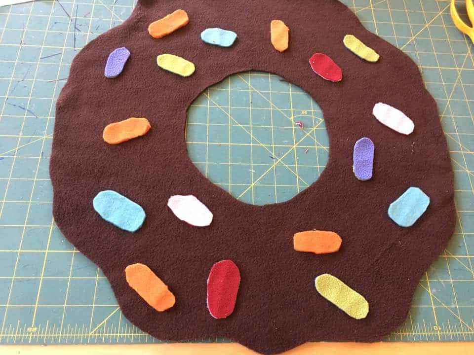 To sew on the doughnut costume sprinkles just zig zag around the edges.