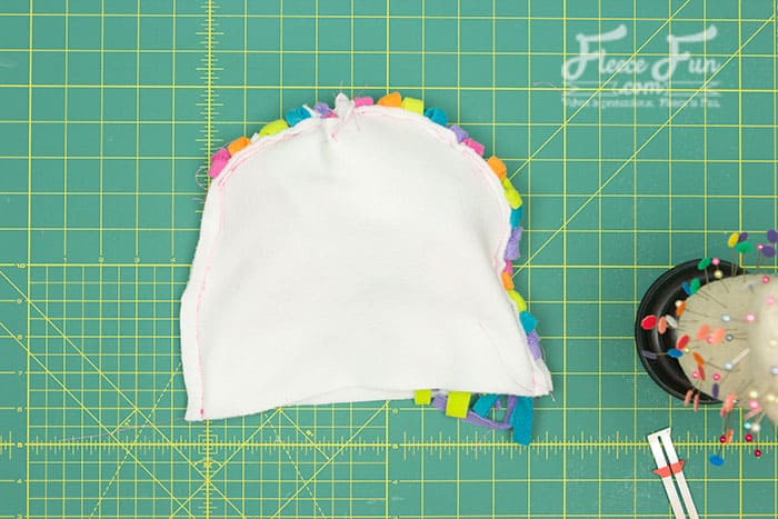 Fleece unicorn hat ears being attached, following FleeceFun's pattern