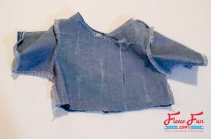 Sewing side seams. This free pattern shows you how to sew a sweet chambray party dress for your 18″ doll. It’s the kind of dress that works for any occasion—casual with boots and a cardigan, fancy with a bolero and shiny shoes. With clear steps and simple sewing, you’ll have dolly dressed to impress before the party starts.