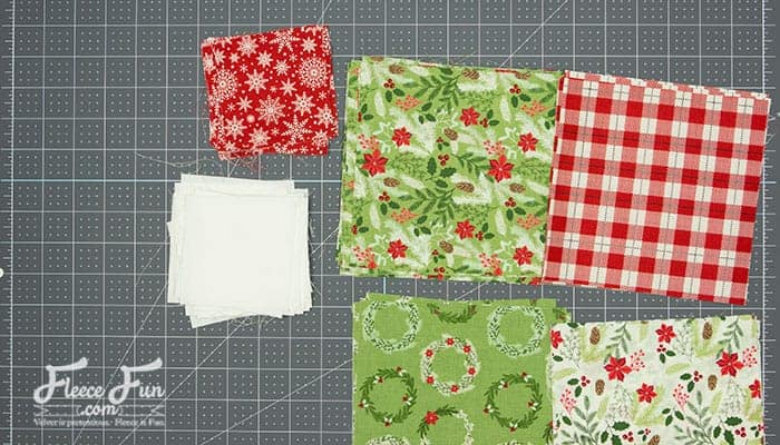 Layering blocks out into neat piles.  Cutting quilt squares used to stress me out—nothing worse than realizing your “perfect square” is actually a lopsided trapezoid In this step-by-step tutorial, you’ll learn how to get flawless cuts every time—without measuring twice (or even once). It's fast, easy, and beginner-approved.