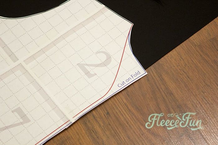You'll notice on the Harry Potter Wizard robe pattern piece that there is a red line. Cutting out Hogwarts robe pieces with fleecefun free template and tutorial