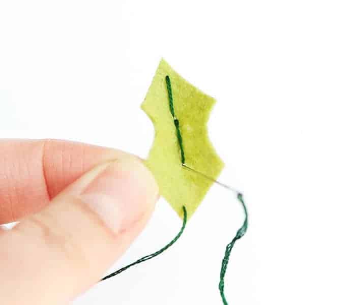 sewing the holly leaves together