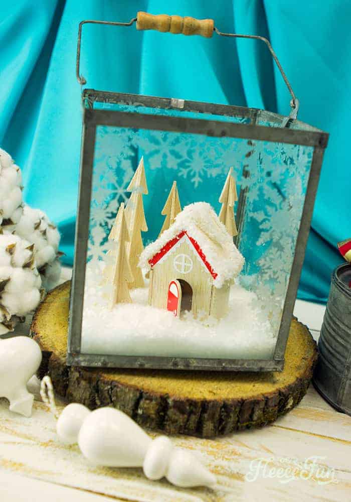 This Christmas Terrarium DIY features wooden elements for a different look. With step by step instructions and lots of pictures this holiday decoration comes together quickly.