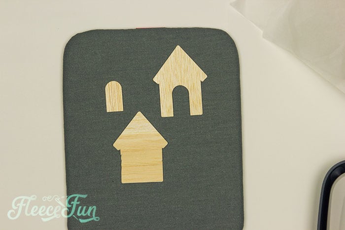 Adding vinyl accents to a miniature house for fleecefun's Christmas terrarium DIY tutorial.