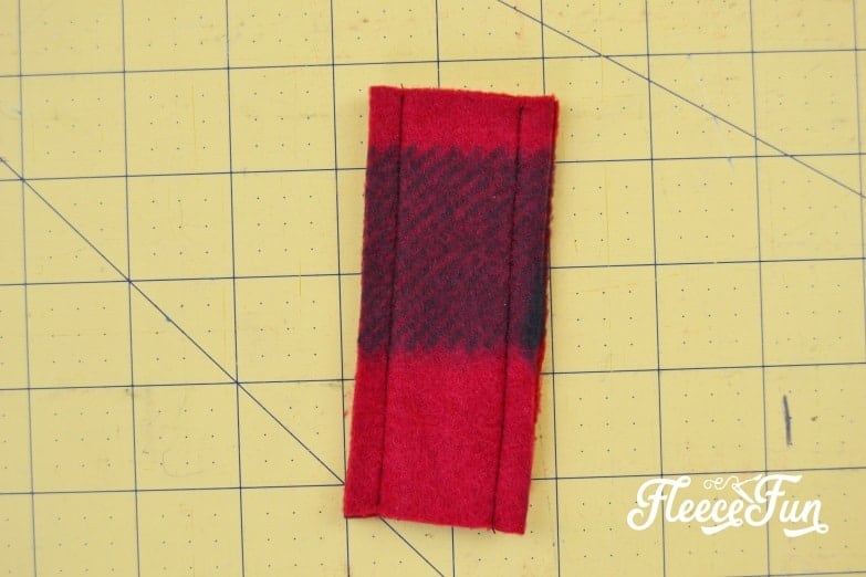 Turn the small fleece tube right side out and create a ring for the ear warmer headband, following fleecefun's tutorial.