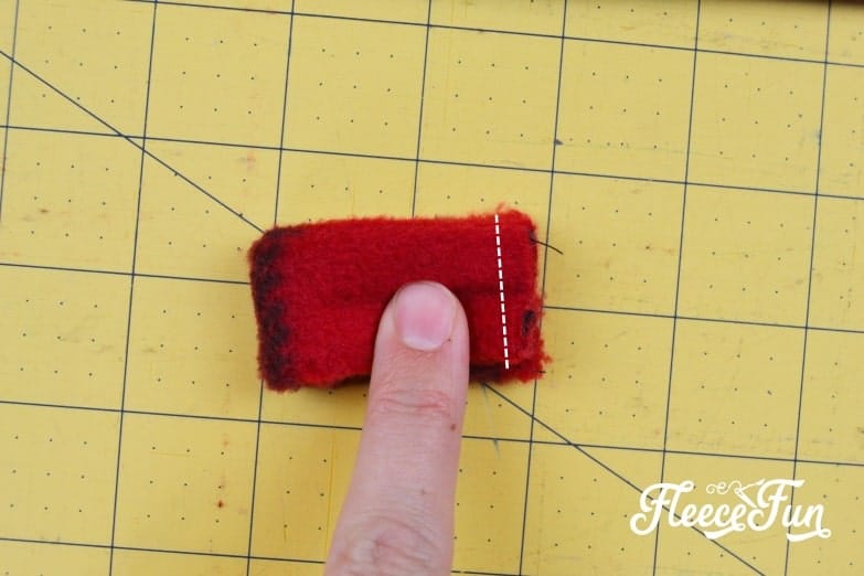 Step 4 of fleecefun's free tutorial – turning the small fleece tube right side out and forming a ring.