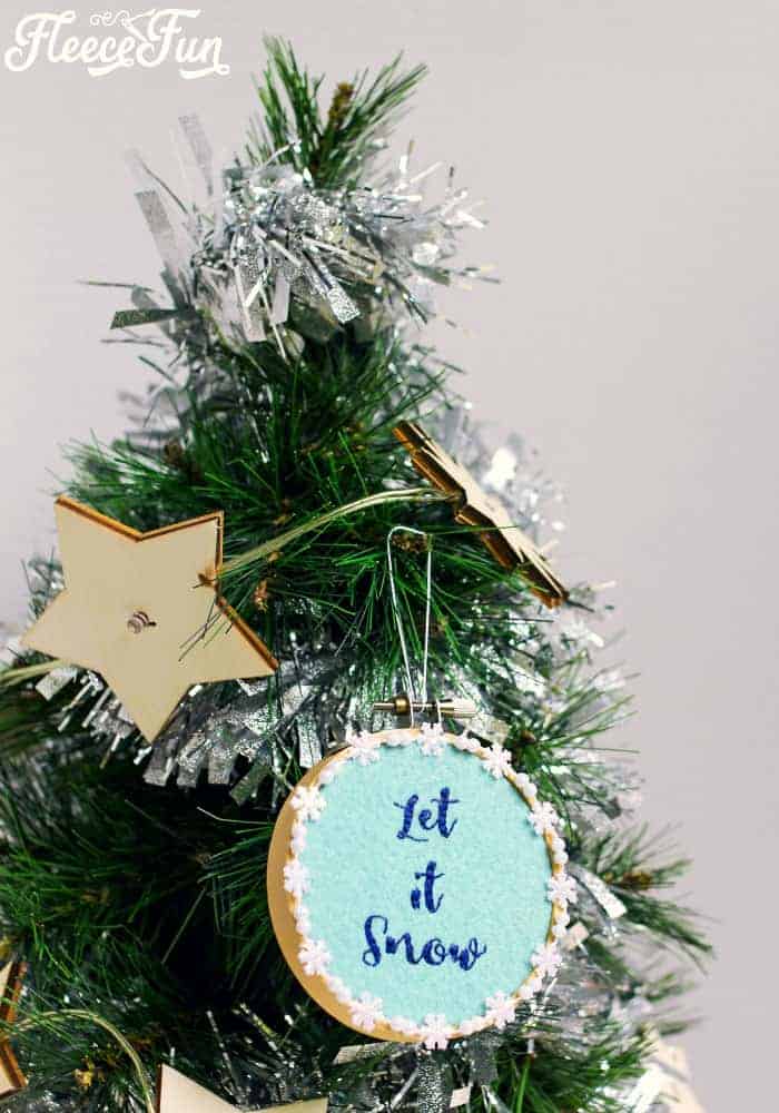 This Let it Snow Embroidery Hoop Ornament DIY makes a wonderful addition to your Christmas tree. Easy step by step instructions and free pattern make this Handmade Ornament a great Christmas craft.