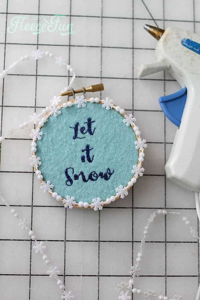 Adding snowflake trim to fleecefun's Let it Snow embroidery hoop ornament.