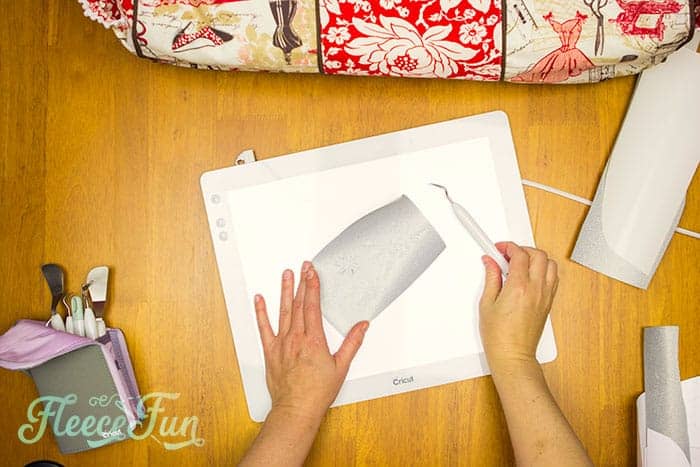 Weeding the vinyl design for the Let Us Sew shirt with fleecefun's free template and tutorial