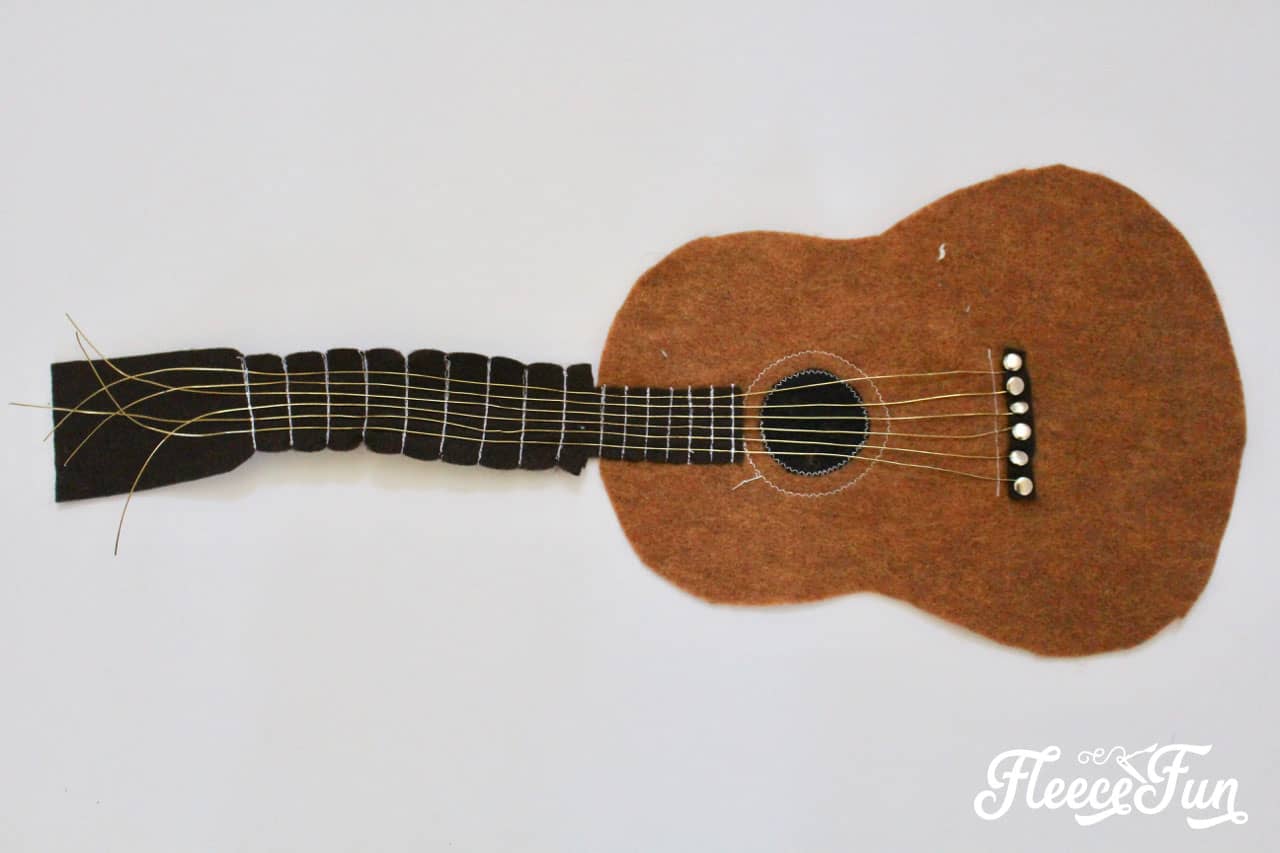 Sewing the Strings and Frets. This Fun Felt Guitar Softie Toy is the perfect addition to your little one's toy collection. With a vintage look, this free softie toy pattern make a perfect handmade gift. Easy to follow step by step pictures and instructions.
