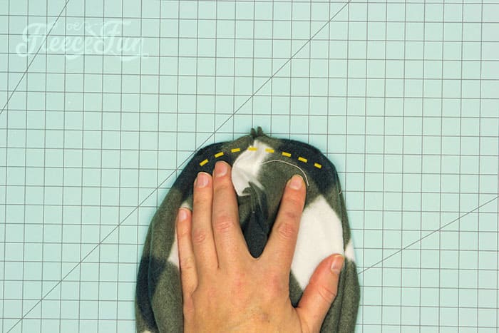 Secure the top of your fleece slouchy beanie by sewing the V shape as instructed by fleecefun.