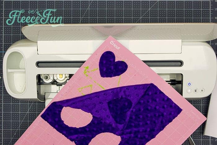 Preparing sensory fabric cutouts for a DIY baby soft book using fleecefun free template and tutorial