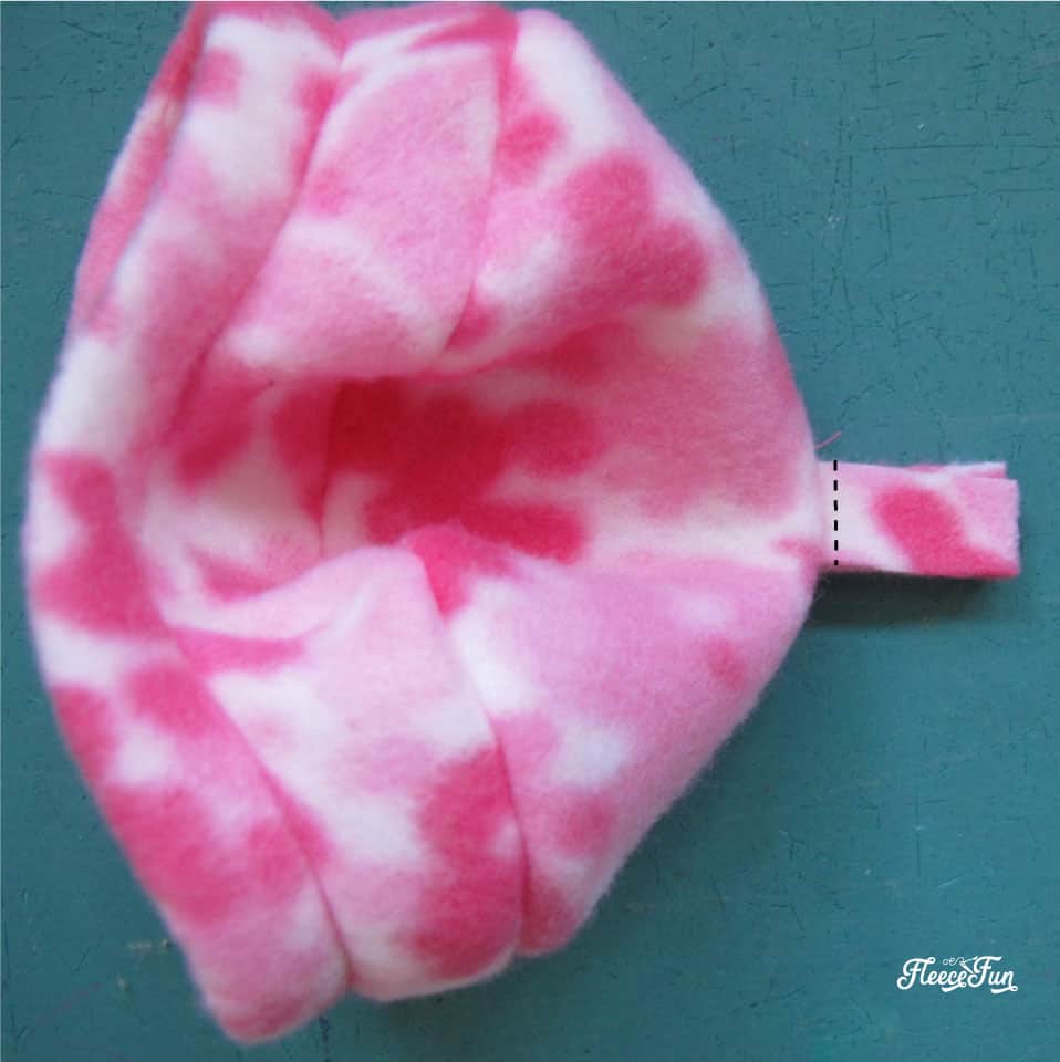 Adding the final stitches to complete the doll hat using Fleece Fun’s free template and tutorial