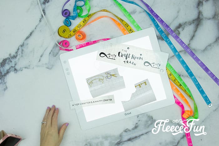 adding the transfer tape - Cute Trash Can DIY for your craft space. Make your craft room tidy and cute with this fun to craft trash can. Beautiful step by step photos make it easy.