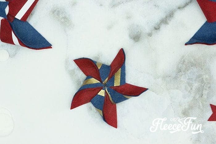 Make the pinwheel shape. There’s just something about red, white, and blue on the front door that makes summer feel official. This DIY Pinwheel Wreath is bold, cheerful, and packed with patriotic charm without looking store-bought. Made with felt pinwheels and a free SVG file, it’s sturdy enough to survive garage mishaps and cute enough to steal the spotlight at your 4th of July party. Ready to spin some Americana magic into your home decor?