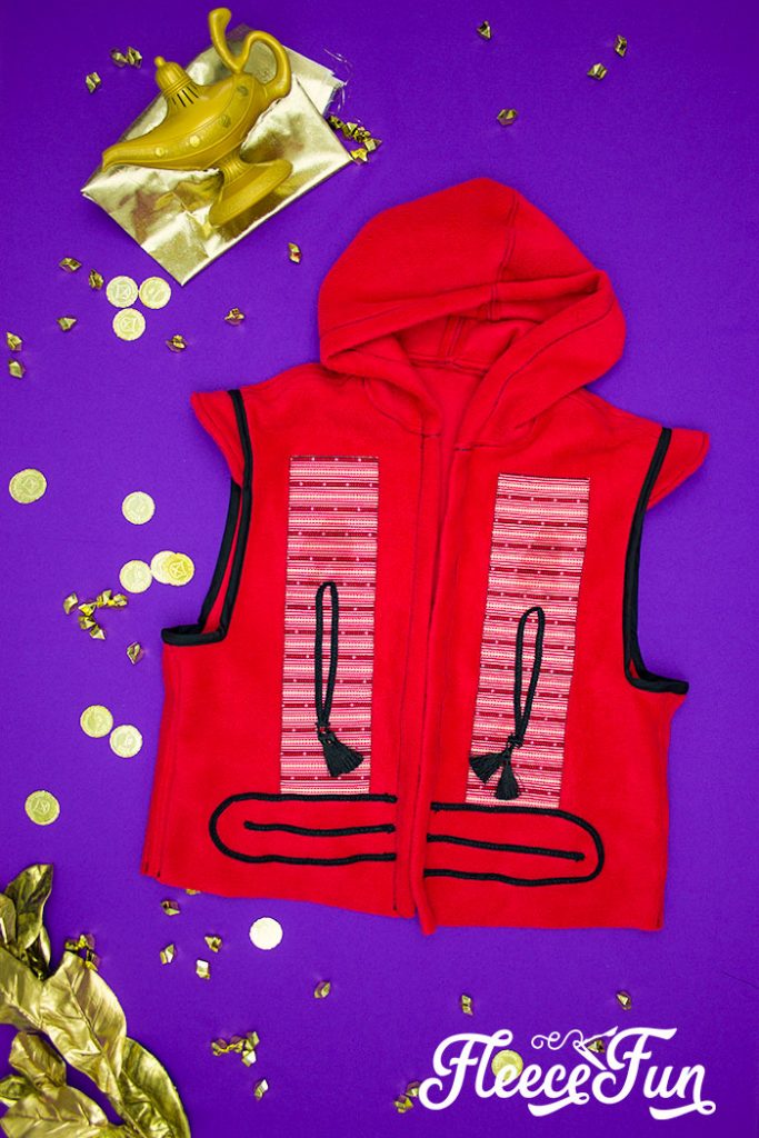 This Aladdin costume DIY is inspired by the Vest from the 2019 movie! Use this free pattern to make a hoodie vest just like Aladdin's.