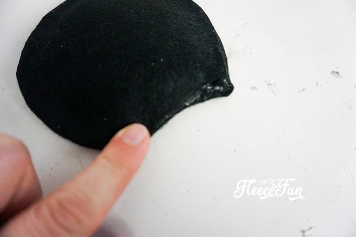 Wrapping the bottom of the loose fabric around to the back.
